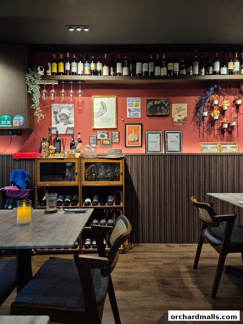 Interior of LaPasta restaurant with wine bottles, decor, and dining tables.