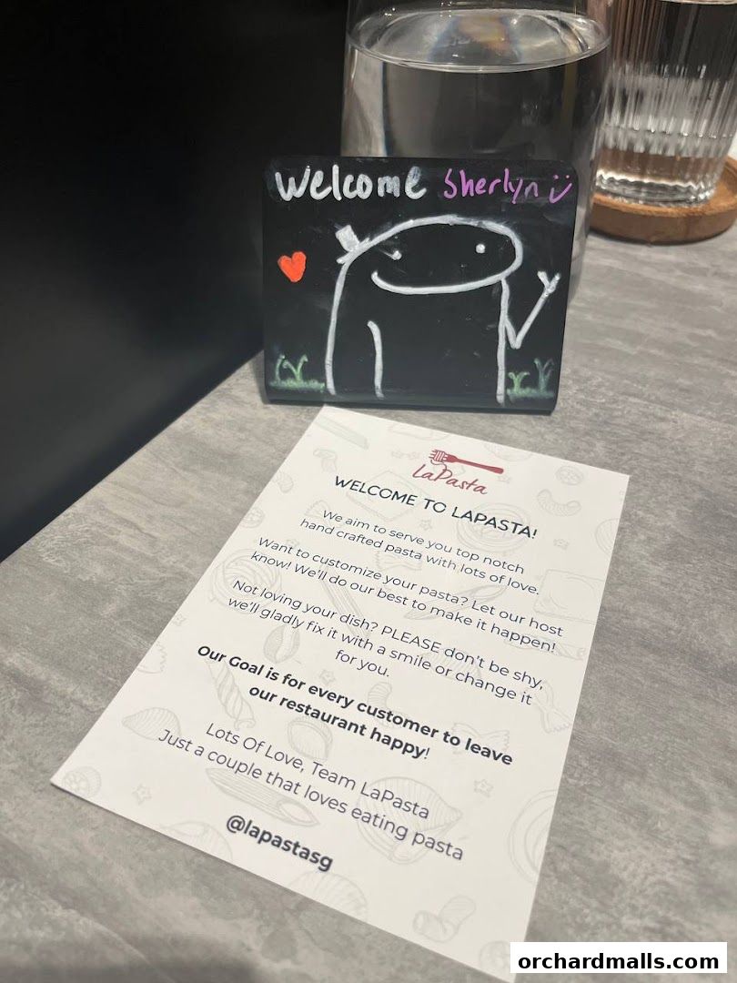 A welcome note and a small chalkboard sign with a drawing at LaPasta restaurant.