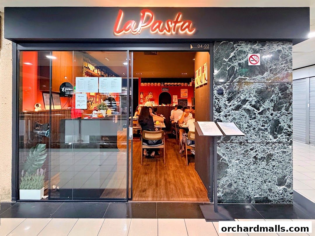 The exterior of LaPasta restaurant, showing its entrance and dining area with customers.