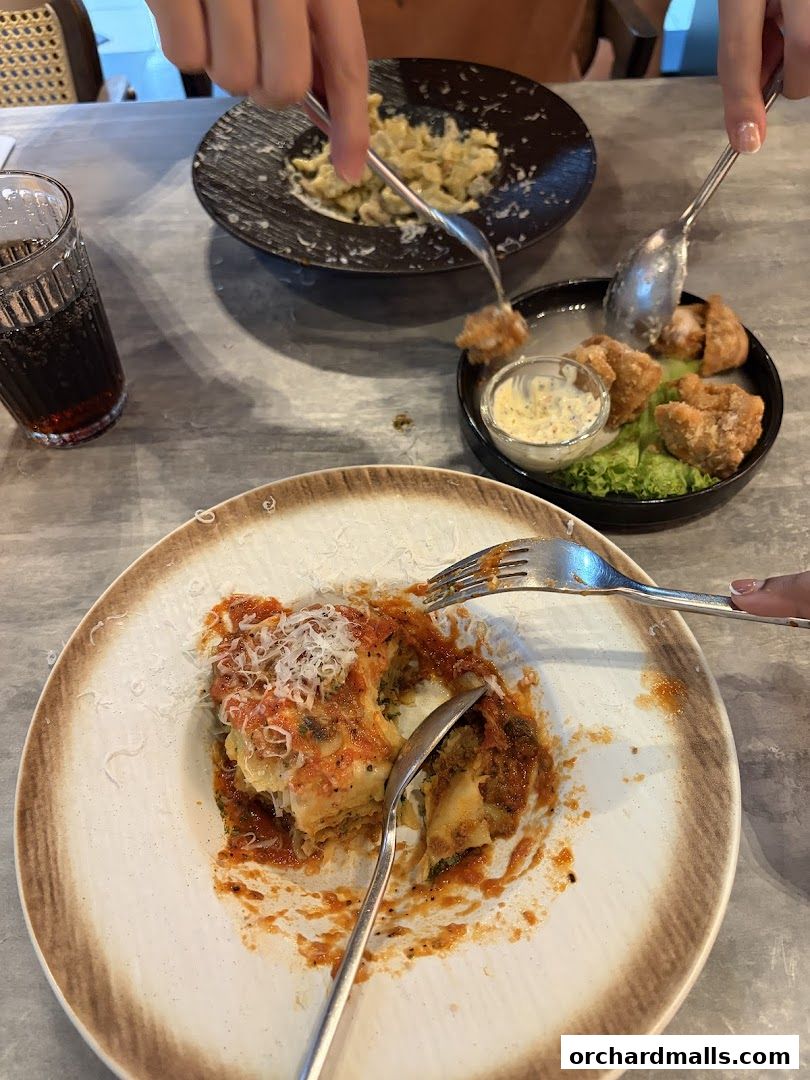 People enjoying pasta dishes and fried appetizers at LaPasta.