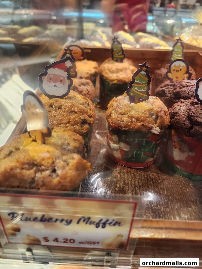 Close-up of blueberry muffins decorated with festive Christmas toppers at Lavender Bakery.
