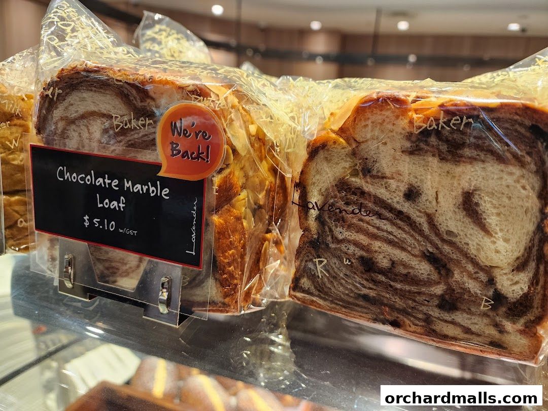 Close-up of a Chocolate Marble Loaf from Lavender Bakery, with a 'We're Back!' sign.
