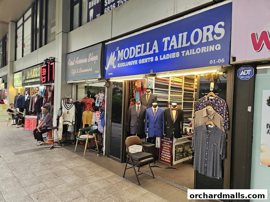 Exterior of Le Modella Tailors shop with mannequins displaying suits and shirts.