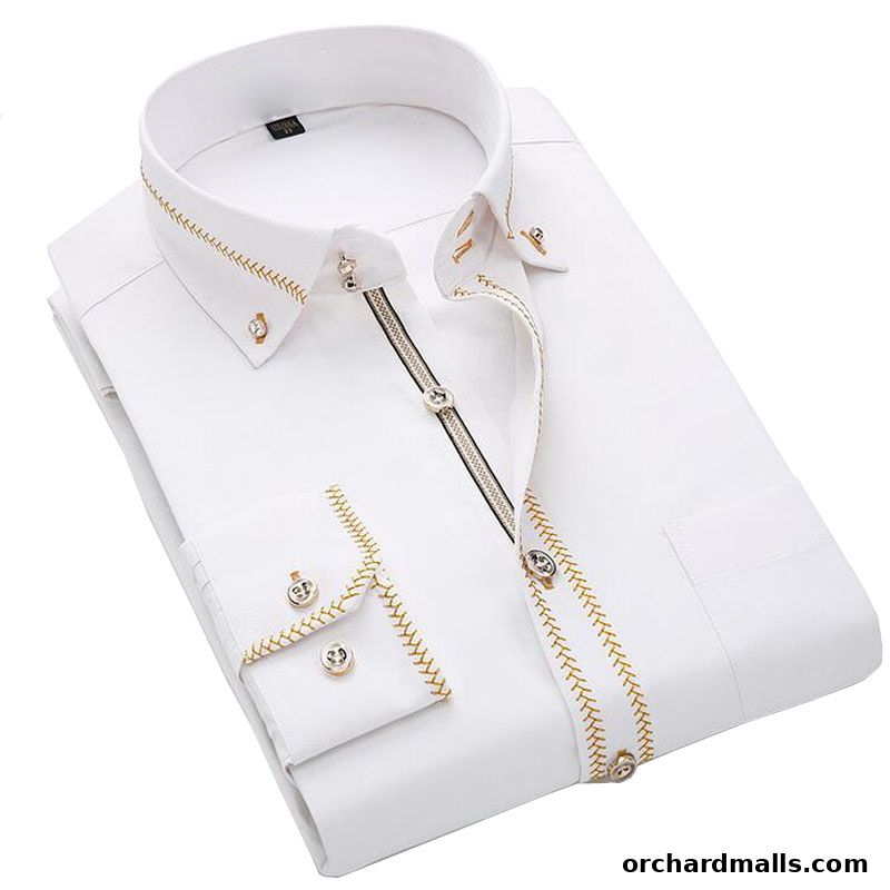 A crisp white dress shirt with intricate gold embroidery and decorative buttons.