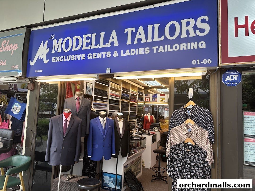 Le Modella Tailors shop front with mannequins displaying suits and shirts.