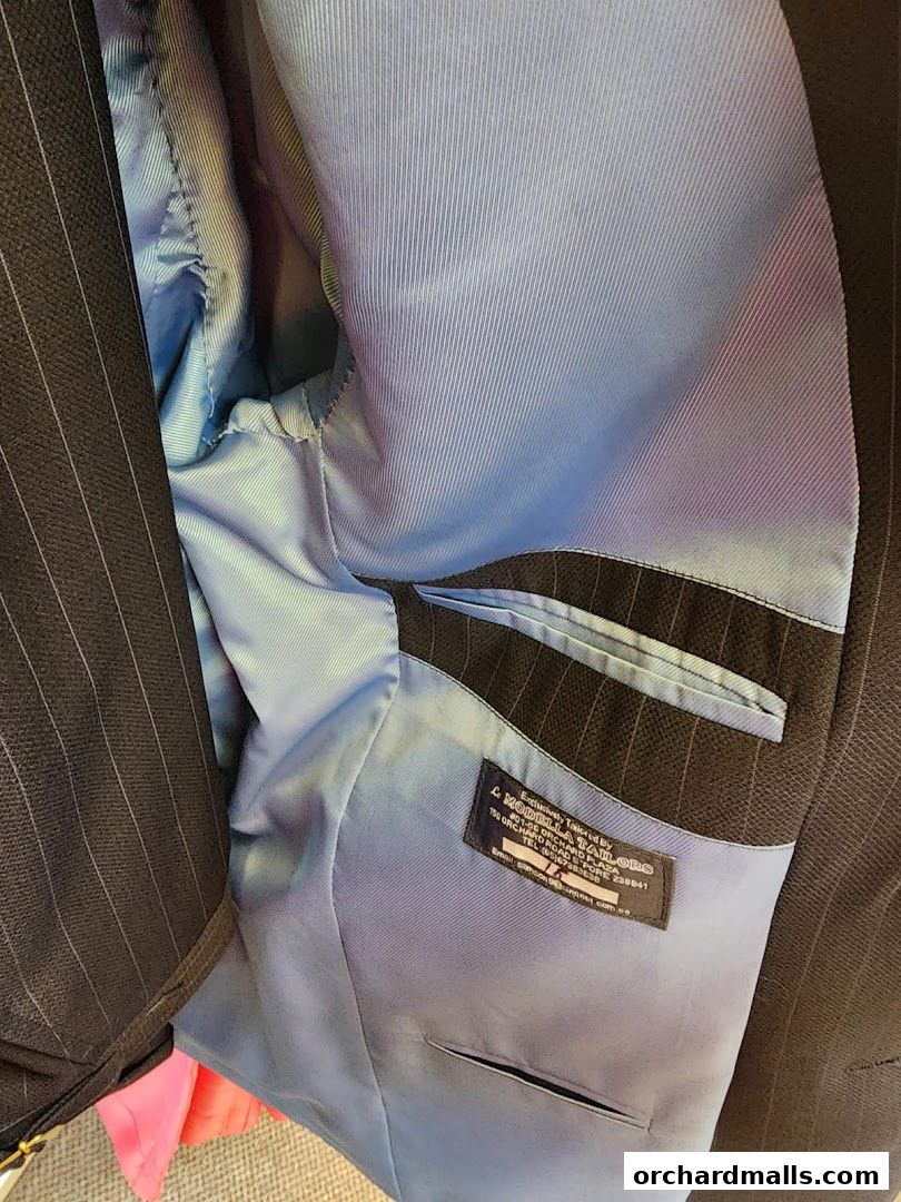 Interior view of a pinstripe suit jacket with a light blue satin lining.