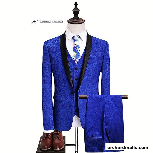 A royal blue patterned suit with a vest, tie, and trousers displayed on a mannequin.