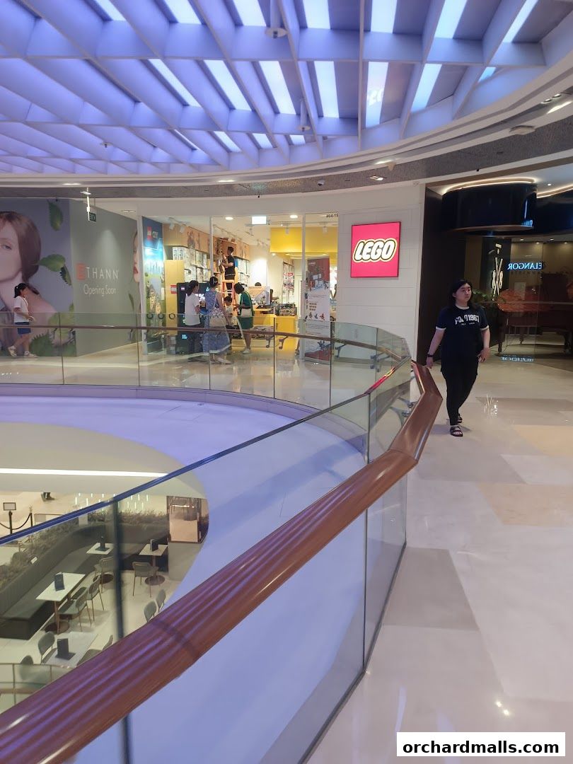 The entrance to a LEGO Certified Store Bricks World with people inside and a LEGO sign.