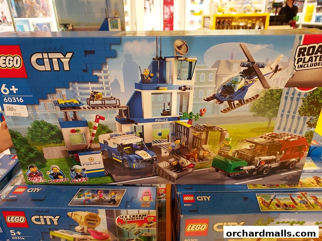LEGO City Police Station playset box with helicopter, police car, and figures.