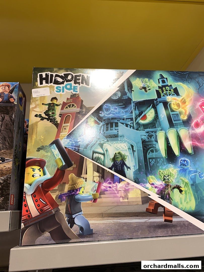 A LEGO Hidden Side playset box featuring characters and a haunted building.