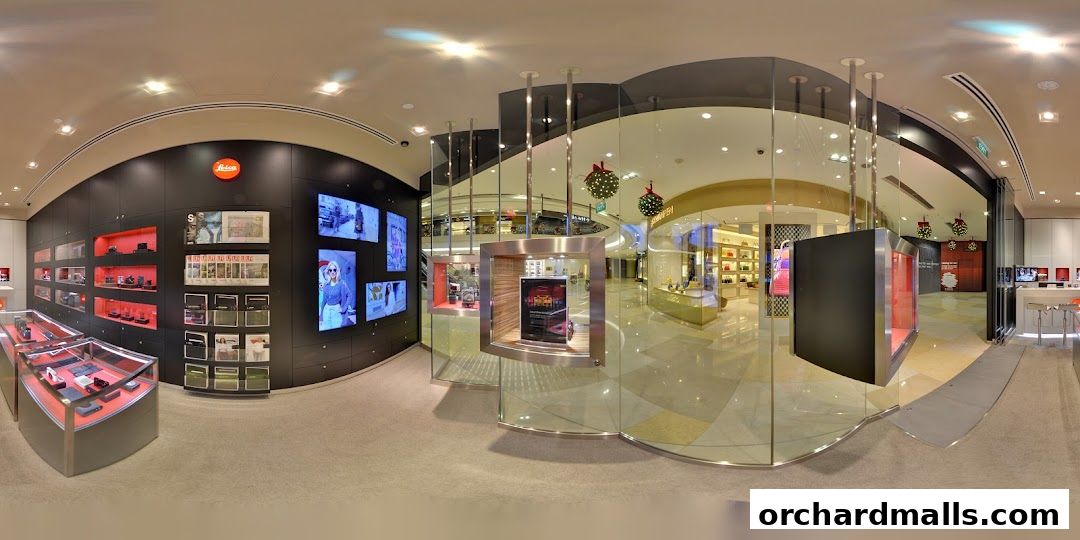 Interior view of a modern Leica store showcasing cameras and accessories with festive decorations.