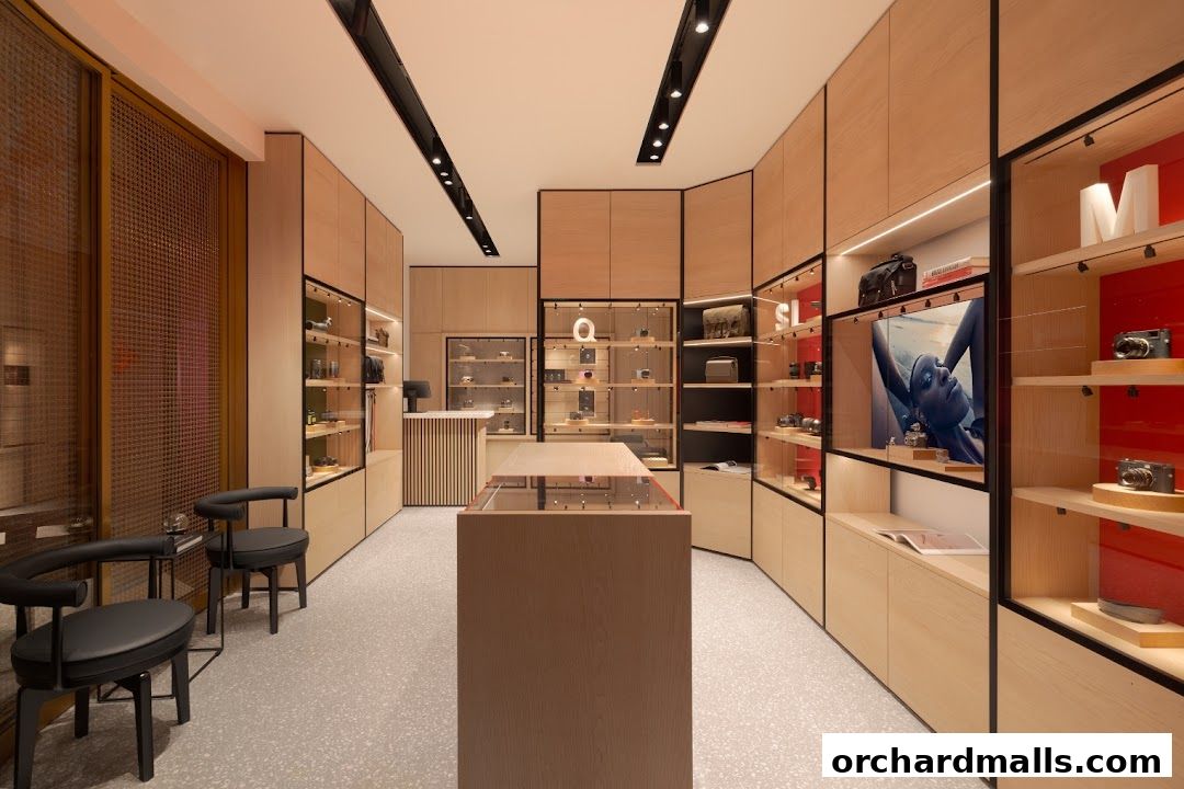 Interior view of a modern Leica store with display cases showcasing cameras and accessories.