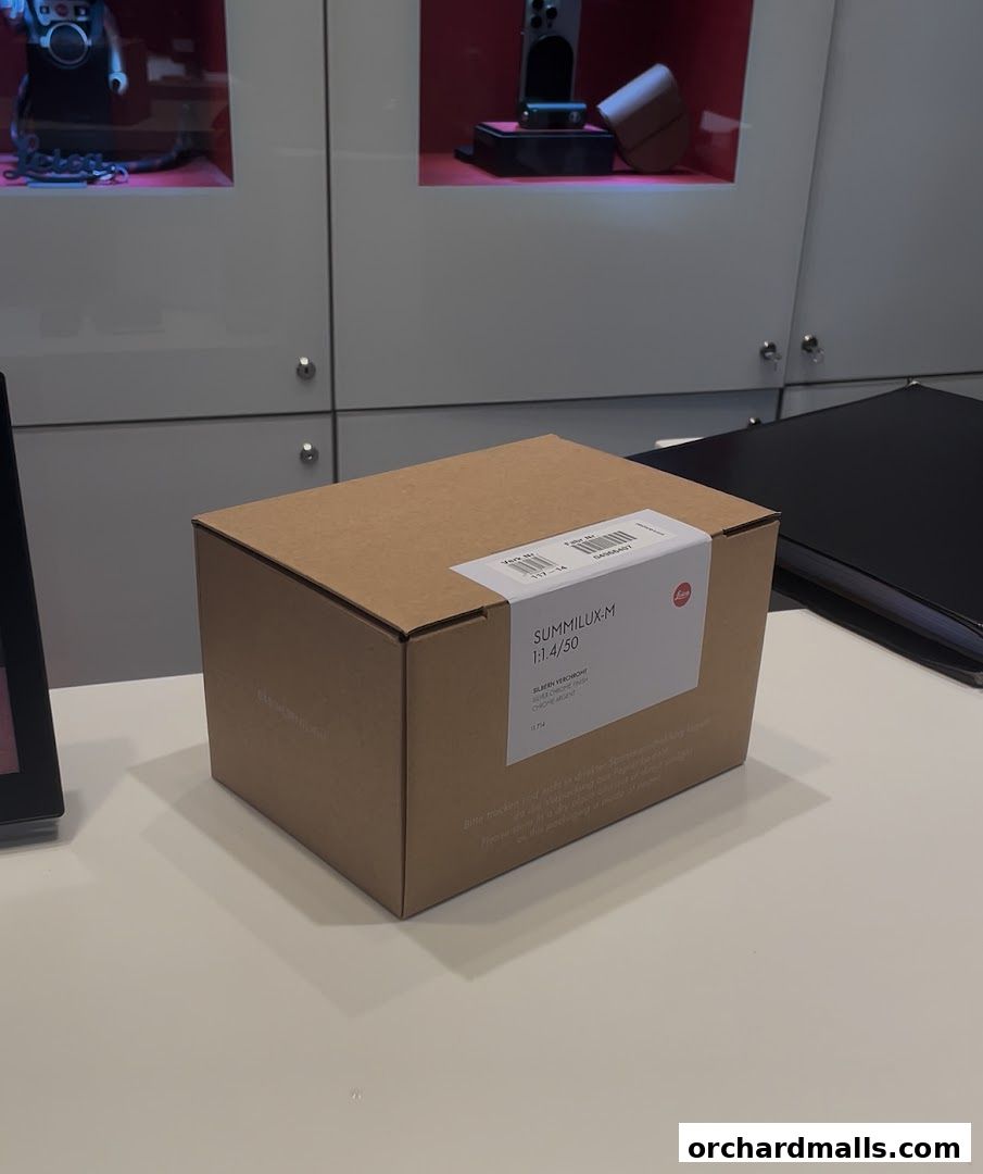 A Leica SUMMILUX-M 1:1.4/50 lens box sits on a counter in a store.