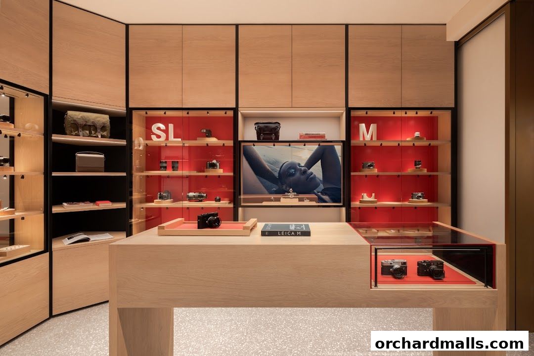 Interior of a modern Leica store showcasing cameras and accessories in illuminated display cabinets.