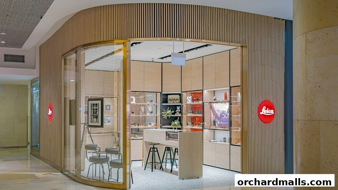 The modern Leica Store ION Orchard features a sleek wooden facade with illuminated signage and display windows.