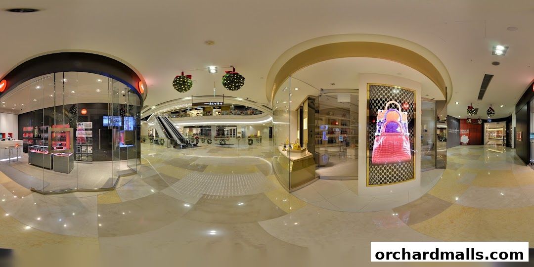 Interior view of a shopping mall with a Leica store and other shops visible.