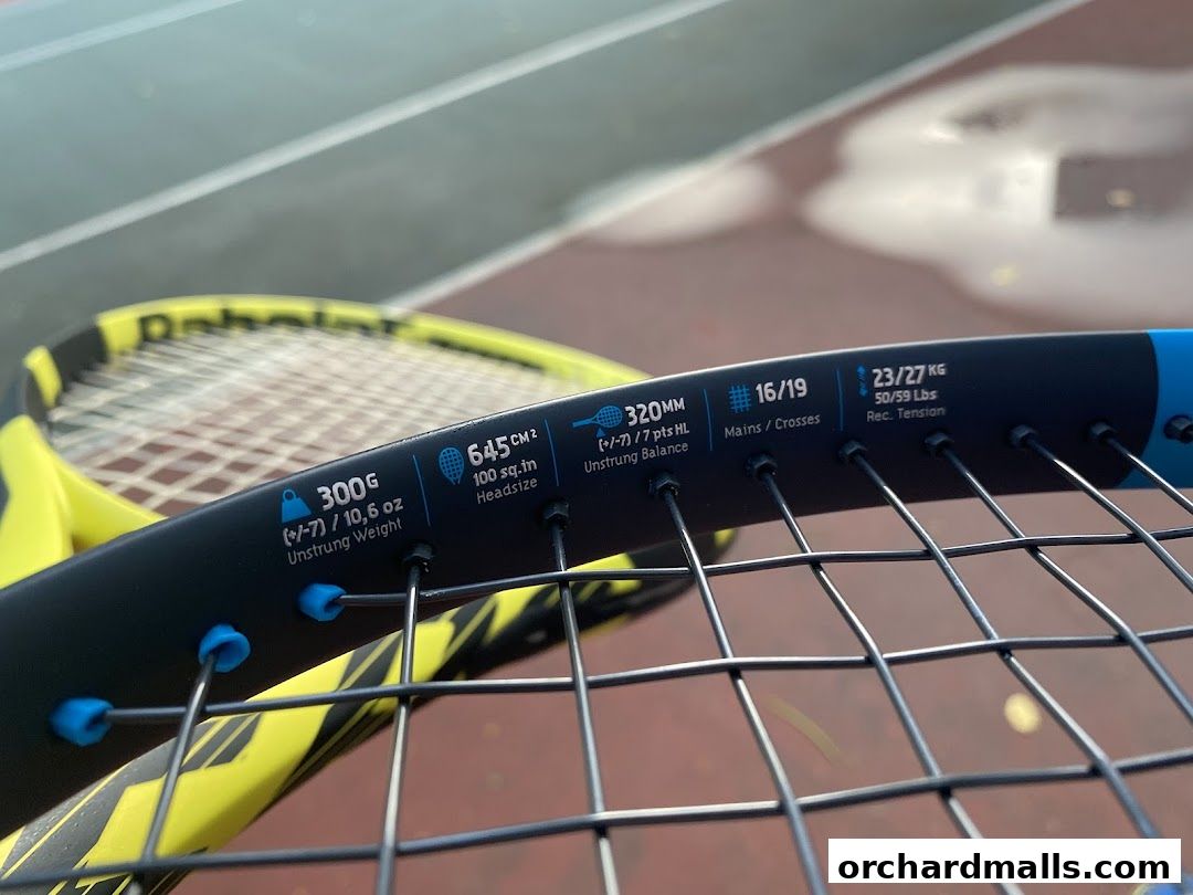 Close-up of a Babolat tennis racket with specifications displayed on the frame.