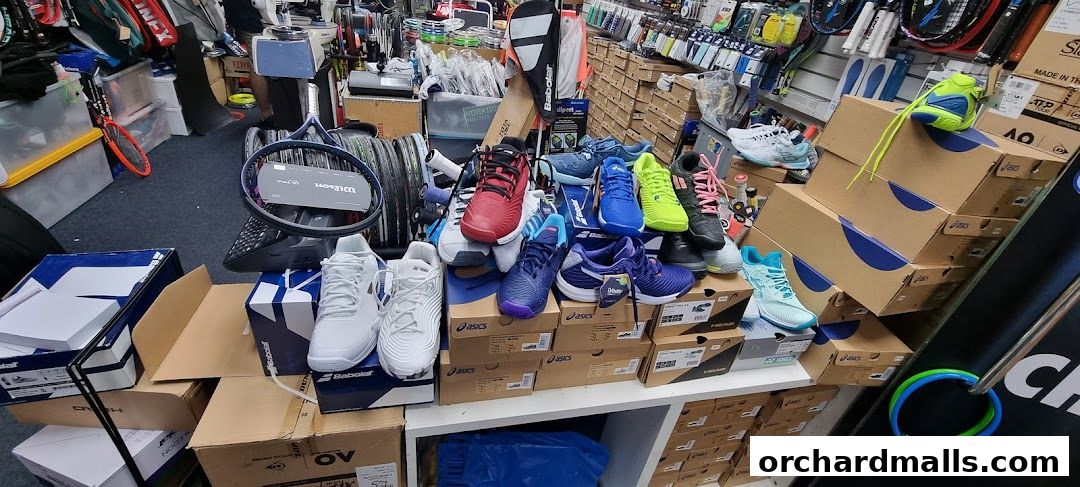 A display of athletic shoes and tennis rackets in a sports equipment store.