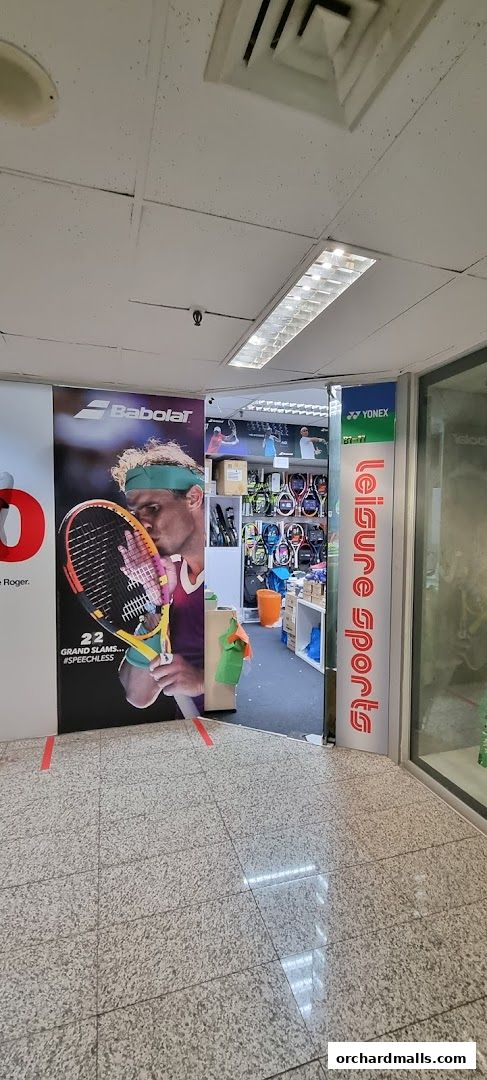 Entrance to Leisure Sports shop, featuring tennis player advertisement and sports equipment display.