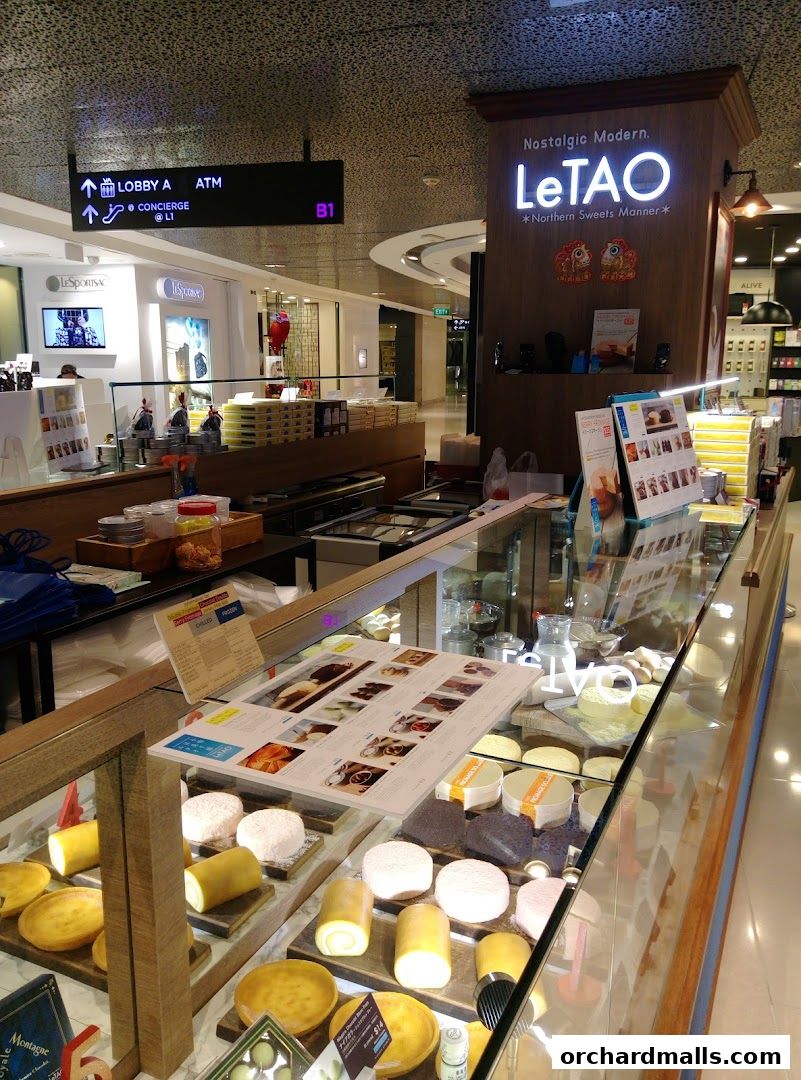 A display case filled with various round and rolled cakes at the LeTAO Singapore shop.