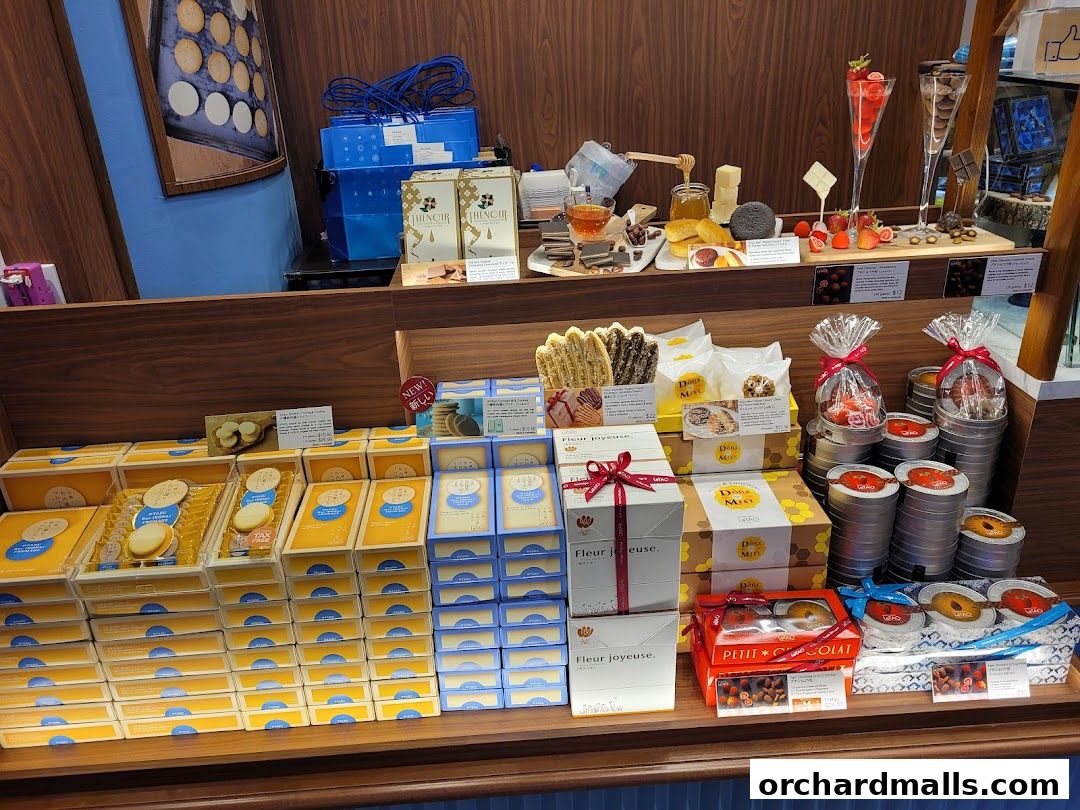 A display of assorted LeTAO sweets and gift boxes, featuring cookies, chocolates, and other confections.