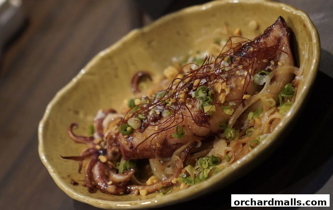 A close-up of a delicious grilled squid dish served in a rustic bowl.