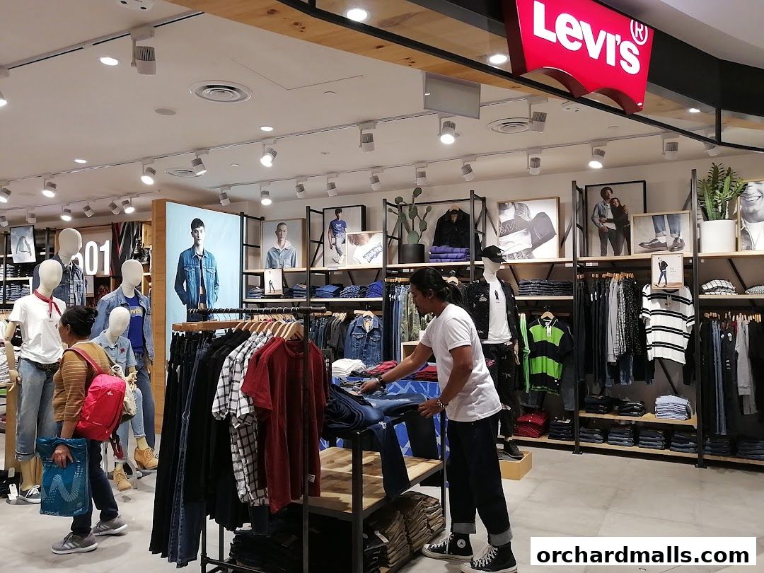 Interior of a Levi's store with mannequins, clothing racks, and promotional images.