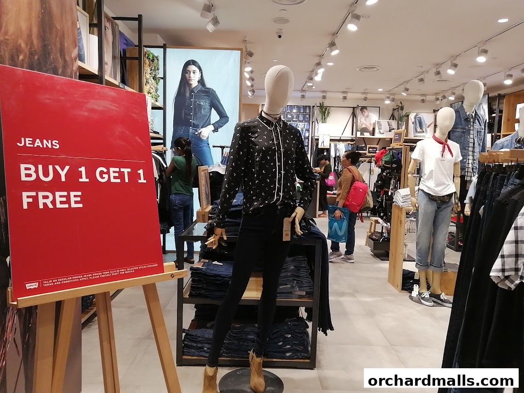 A Levi's store interior with mannequins, jeans displays, and a 'Buy 1 Get 1 Free' sign.