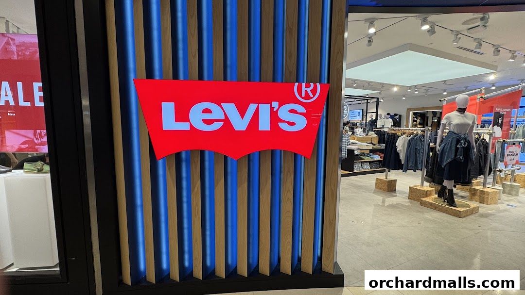 The entrance to a Levi's store with its iconic logo and displays of denim clothing.