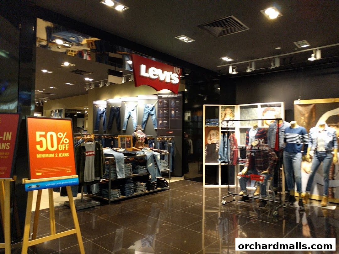 Interior of a Levi's store showcasing jeans and apparel with a 50% off promotion.