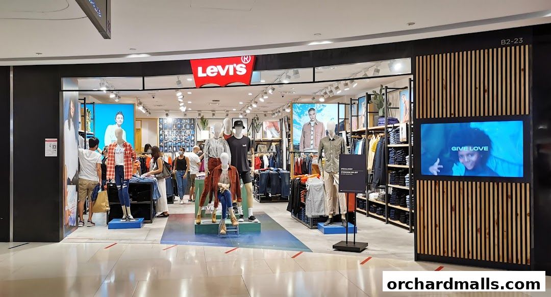 The entrance of a Levi's store with mannequins displaying clothing and a digital screen.
