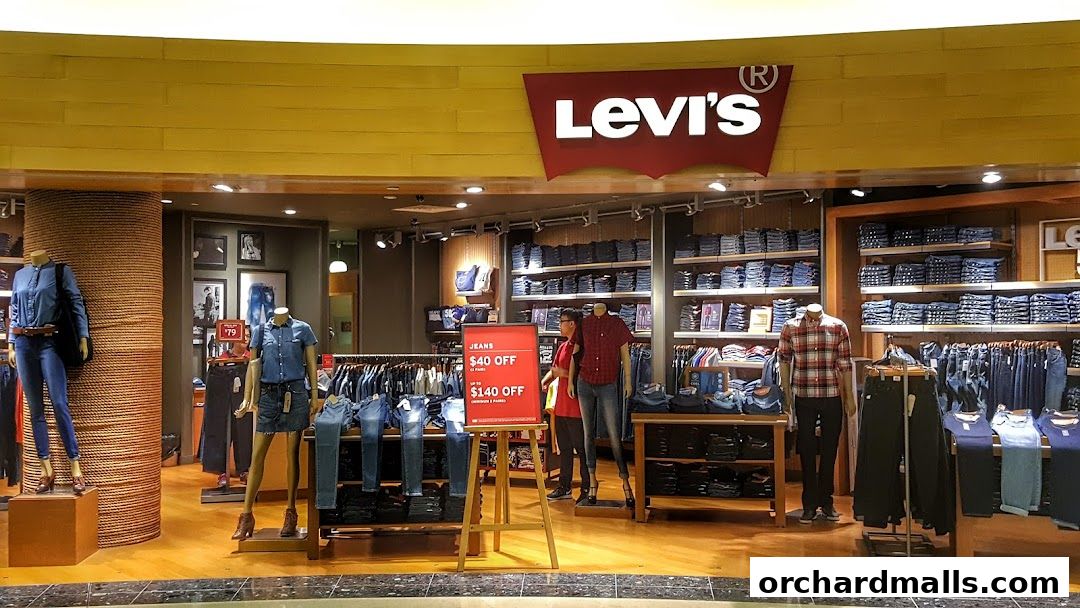 The Levis store at ION Orchard showcases a wide selection of jeans and apparel with mannequins displaying outfits.