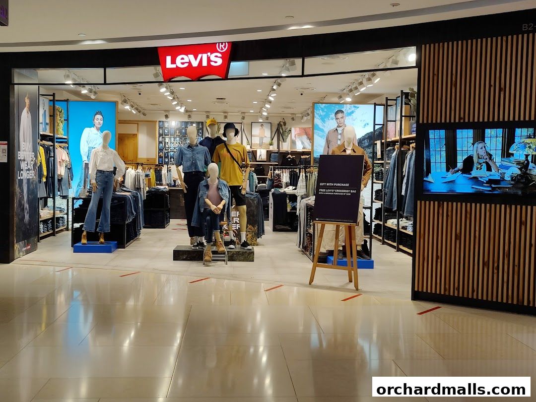 The Levis store at ION Orchard features mannequins showcasing denim outfits and a promotional sign.