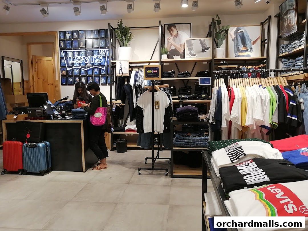 Interior view of a Levi's store with clothing displays and customers at the counter.