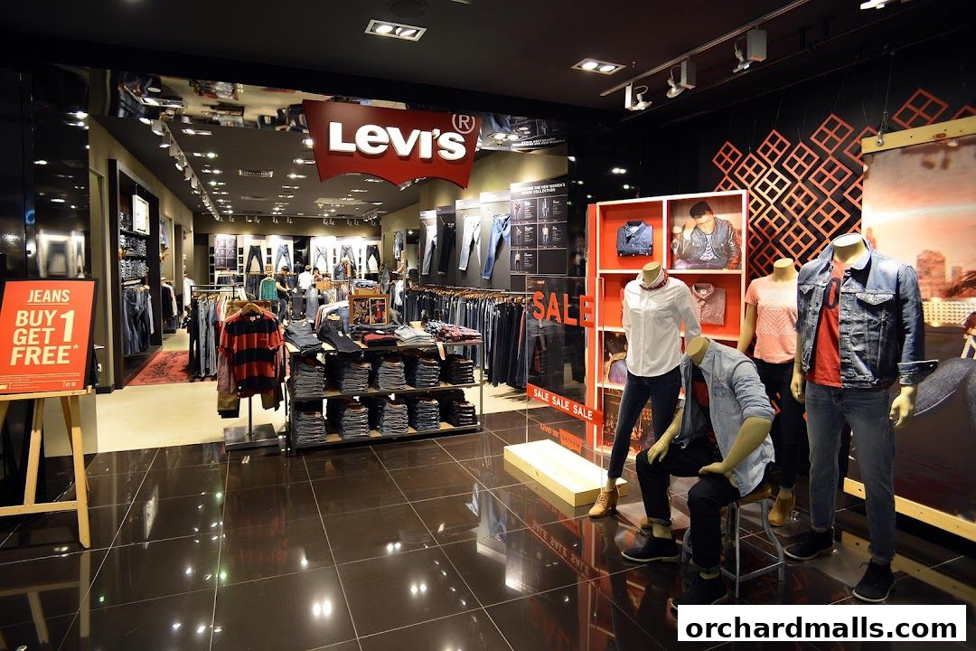 Interior view of a Levi's store showcasing jeans, apparel, and mannequins with sale signage.