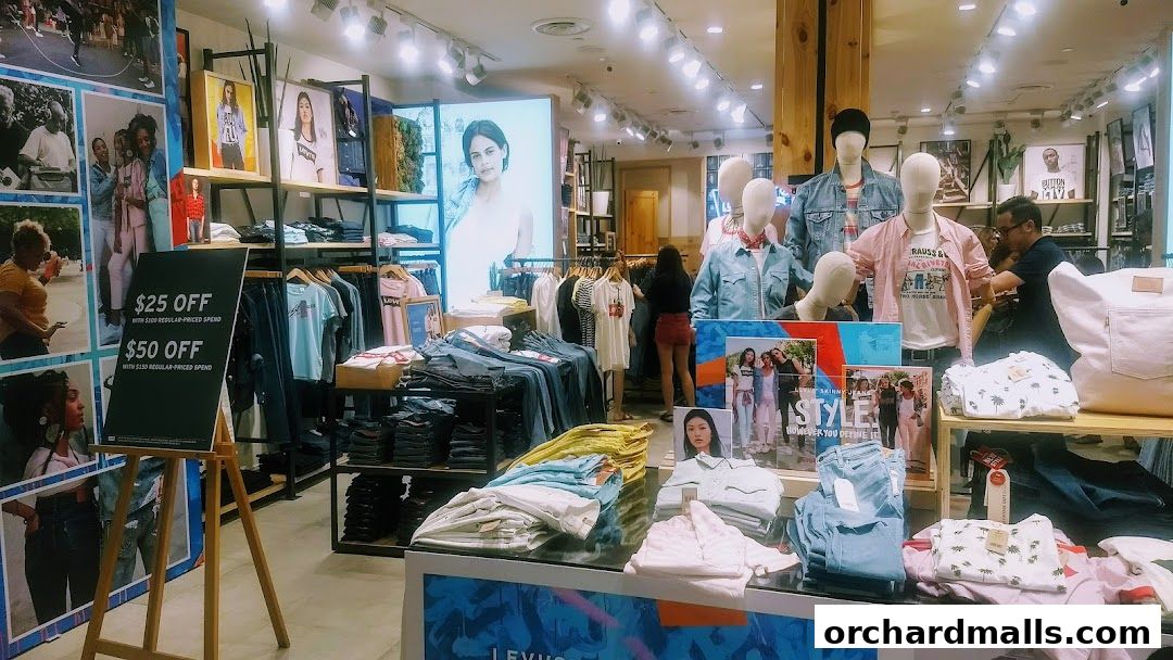 Interior of a Levi's store showcasing denim apparel, mannequins, and promotional signage.