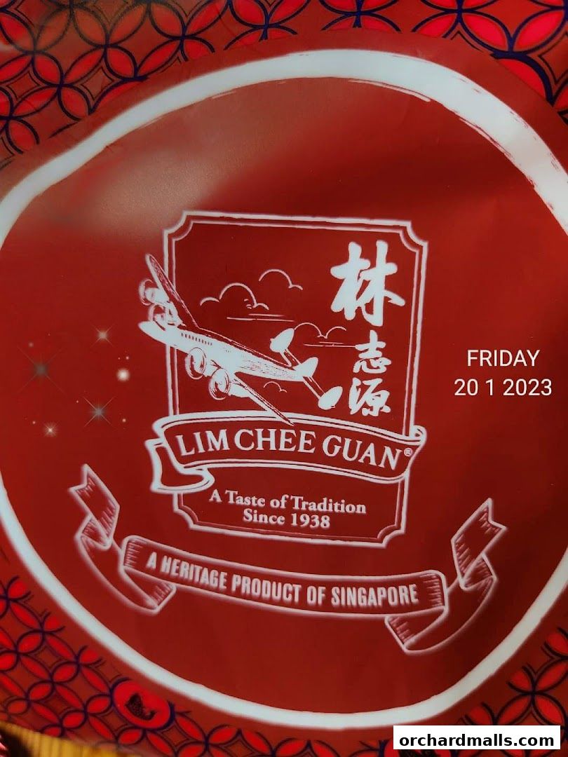 A close-up of a red circular item with the Lim Chee Guan logo and text.