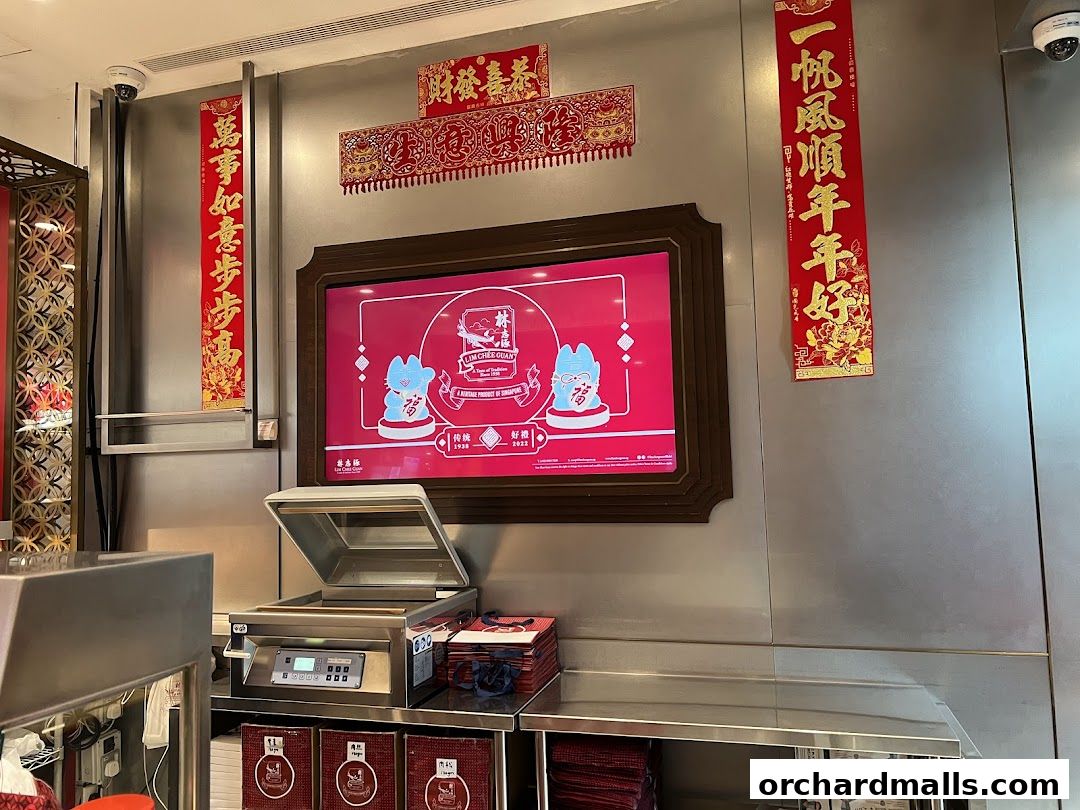 Interior shot of Lim Chee Guan store with festive decorations and a digital display.