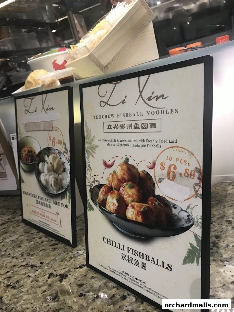 Two menu boards displaying Teochew Fishball Noodles and Chilli Fishballs.