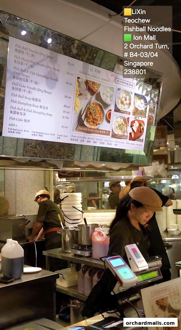 A menu board displays various fishball noodle dishes with prices and images.