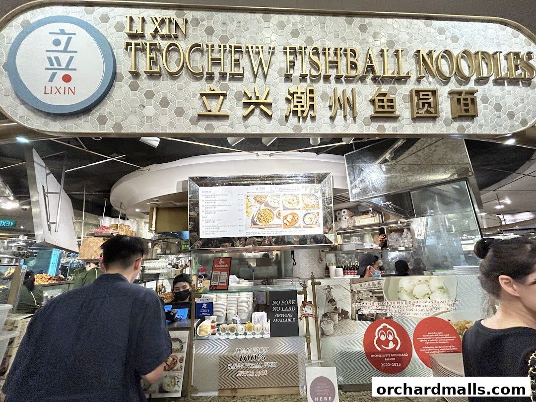 LiXin Teochew Fishball Noodles shop front with menu and awards displayed.