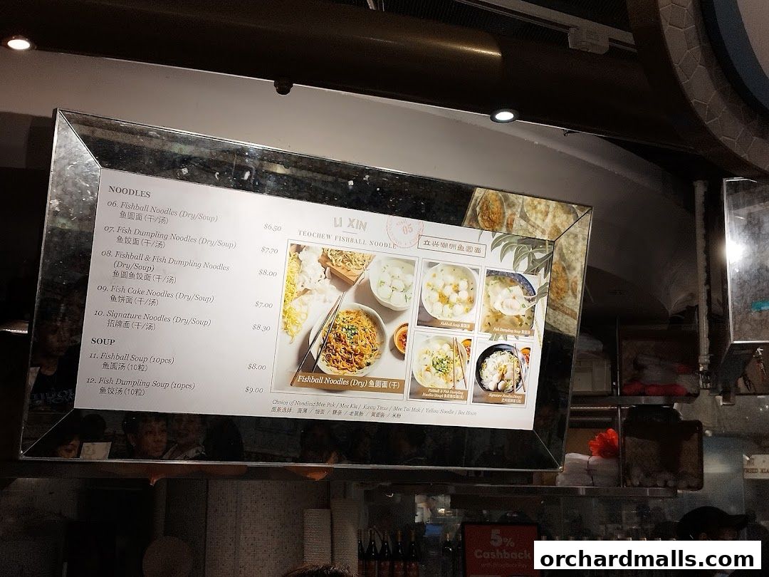 A menu board displaying various fishball noodle dishes and soups with prices.