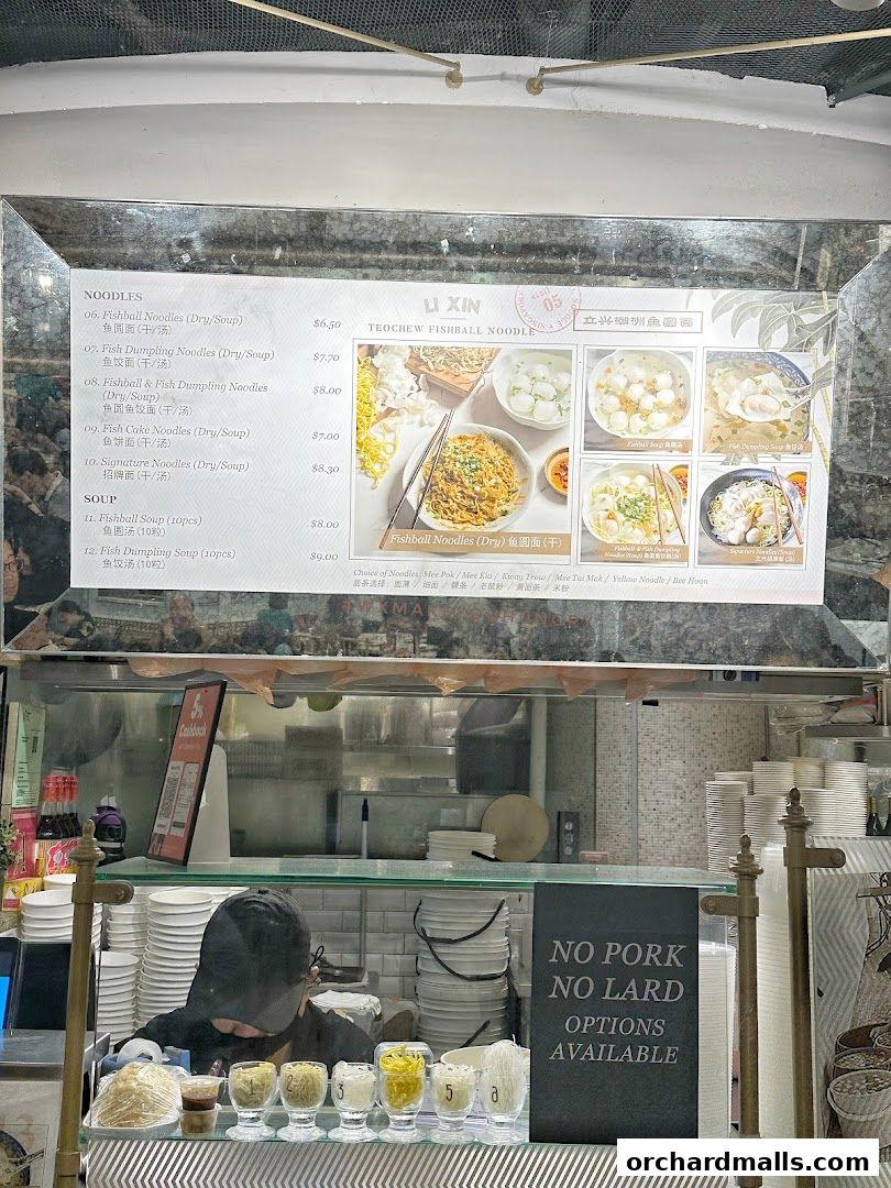 A menu board for Li Xin Teochew Fishball Noodles with various noodle and soup options.