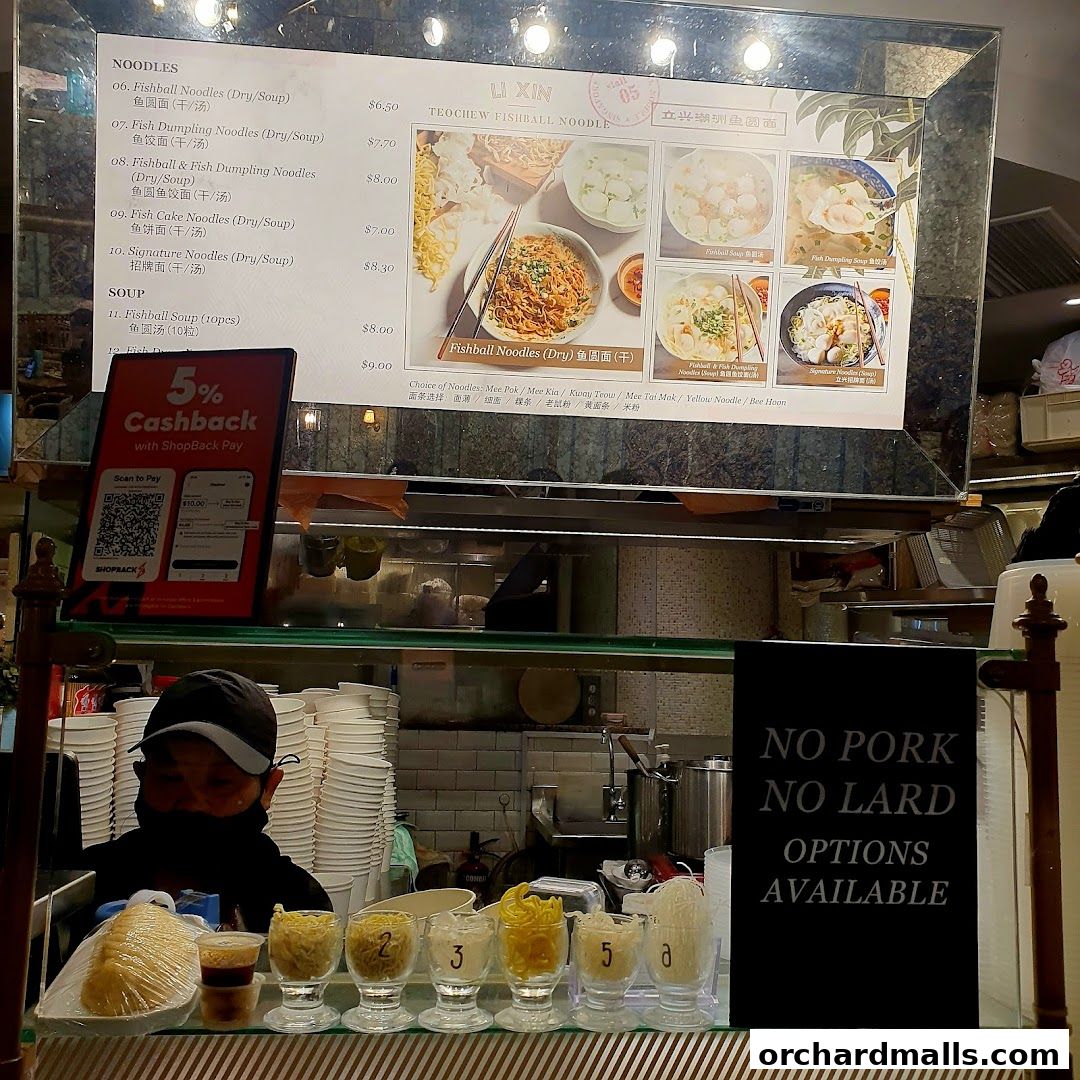 A menu board for Li Xin Teochew Fishball Noodles with various noodle dishes and soup options.
