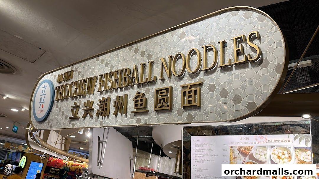 A sign for Li Xin Teochew Fishball Noodles with a menu displayed below.