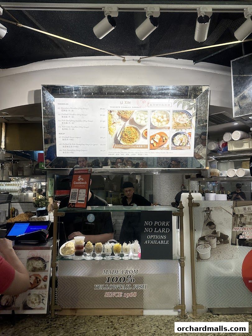 A menu board for Li Xin Teochew Fishball Noodles with various noodle and soup options.