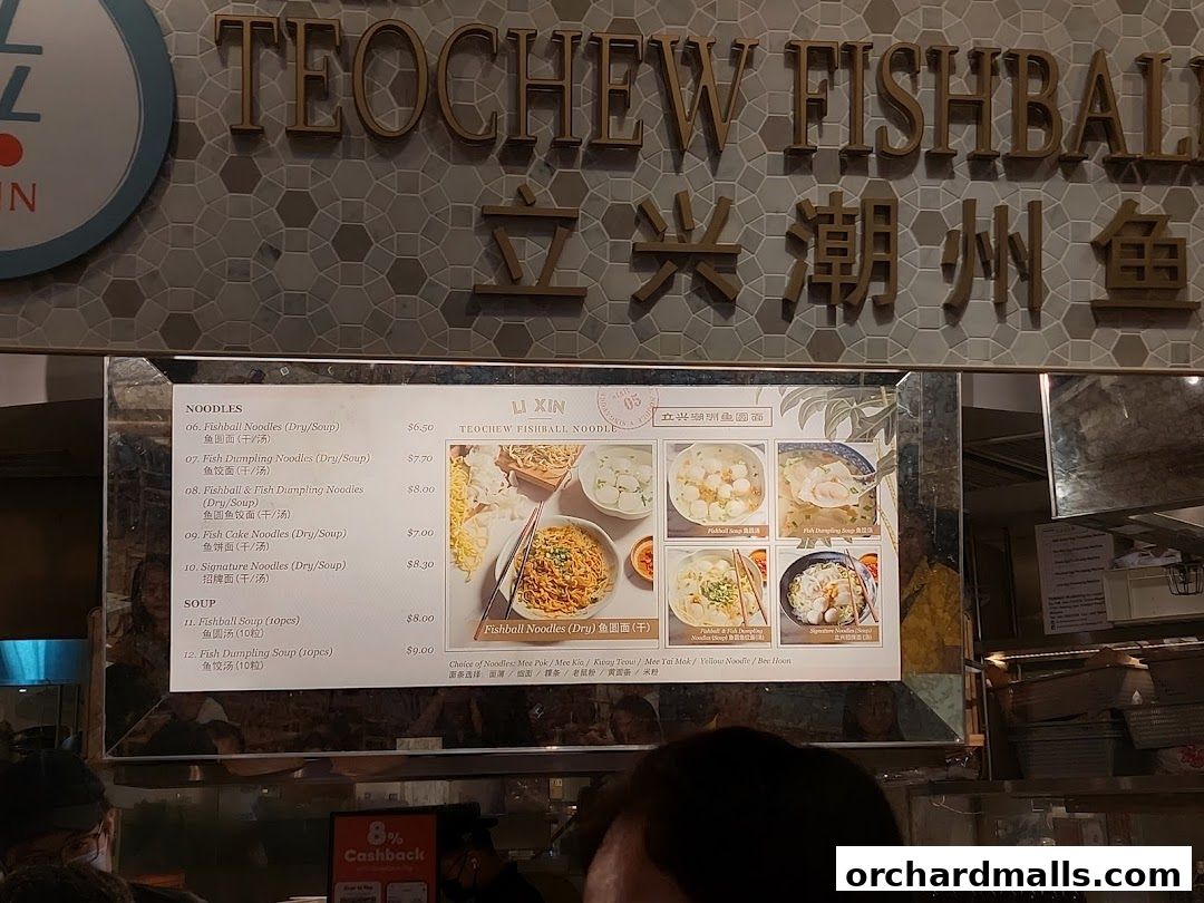 A menu board for Li Xin Teochew Fishball Noodles with various noodle and soup options.
