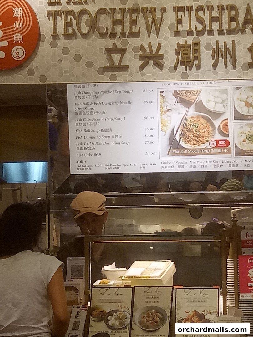 A menu board for LiXin Teochew Fishball Noodles with various noodle and fishball dishes.