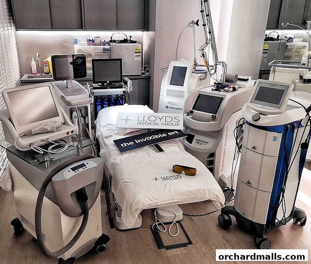 Interior of a medical spa with advanced aesthetic treatment machines and a treatment bed.