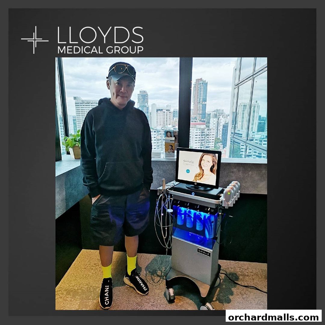 Man standing next to a medical aesthetic device with a city view.